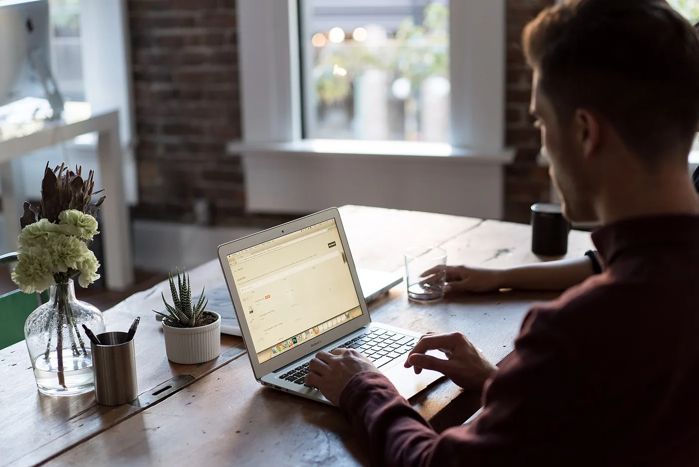 A person works at a laptop to visualise a design before anything is manufactured.