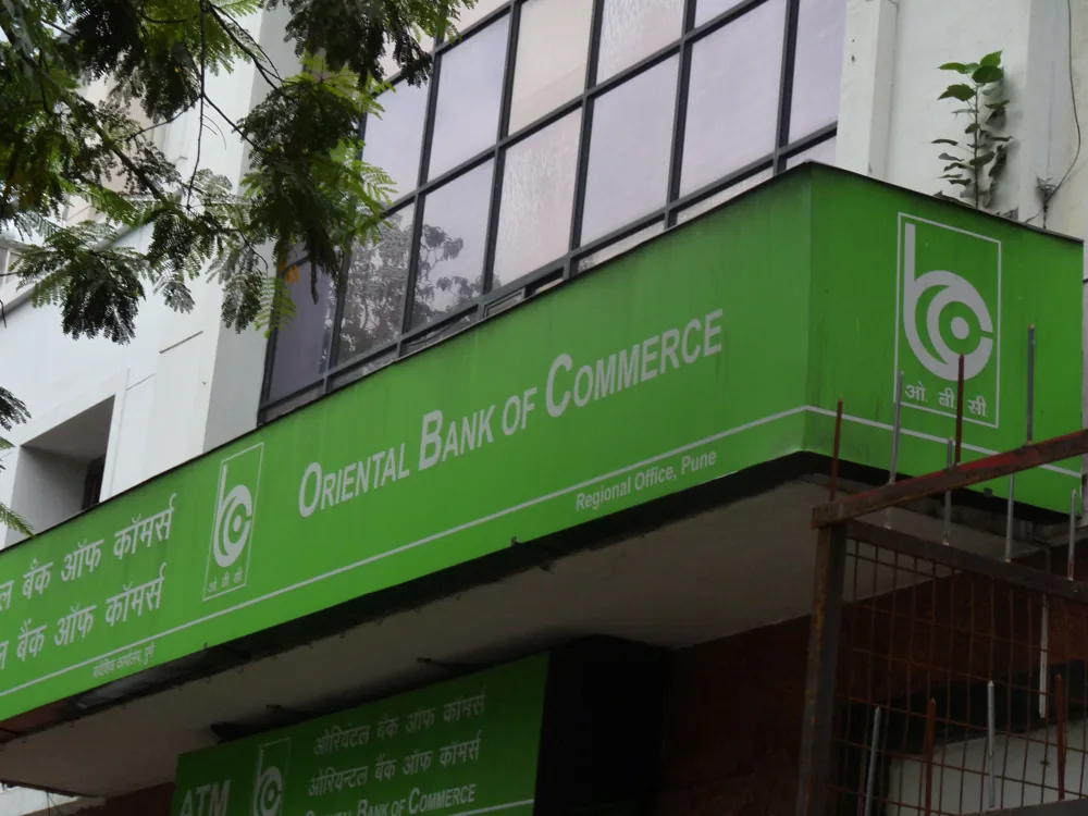 Oriental Bank of Commerce fascia in Pune, with scaffolding at the sign while it is maintained.