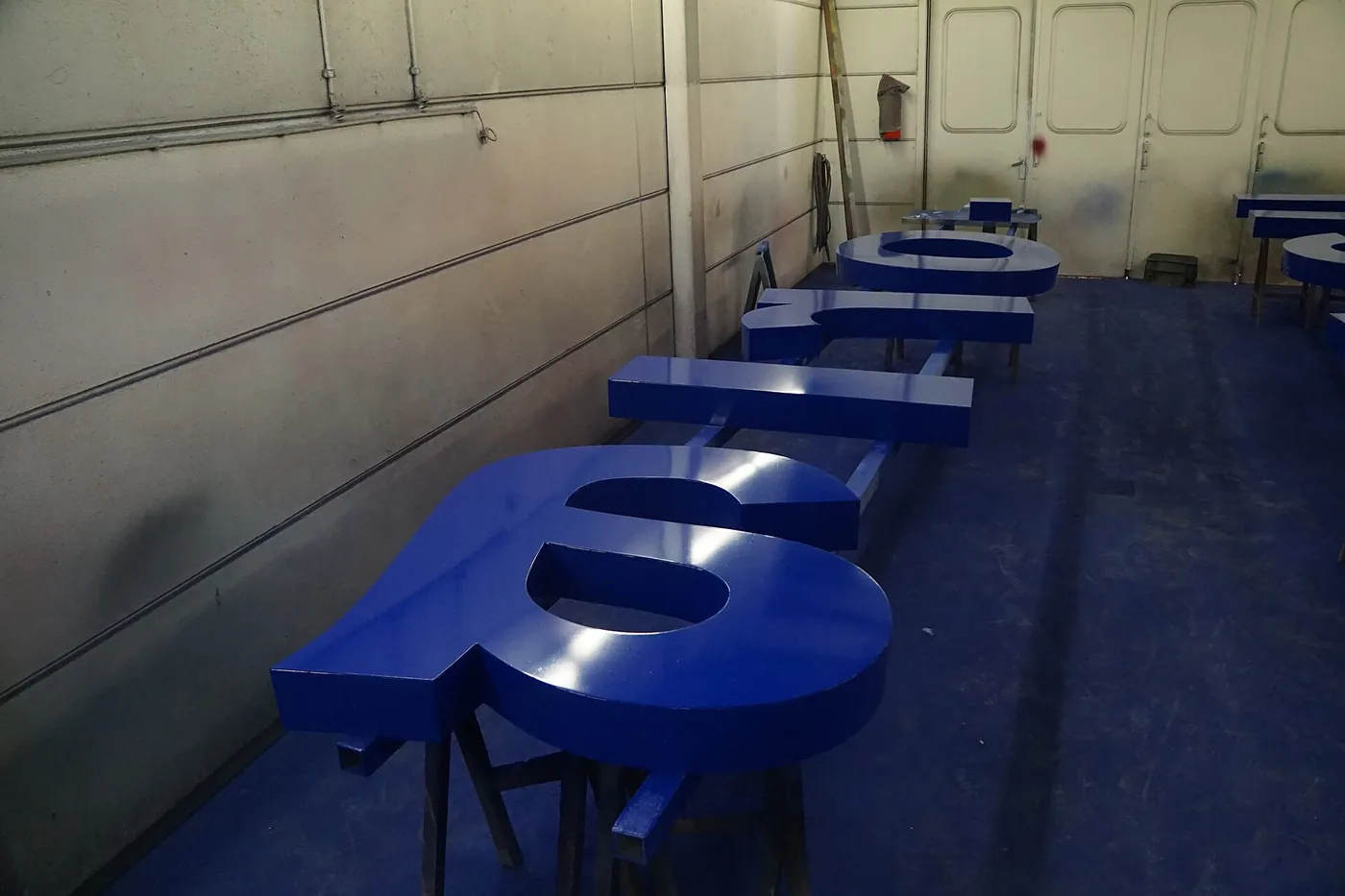 Painted dimensional letters finished in a sign workshop.