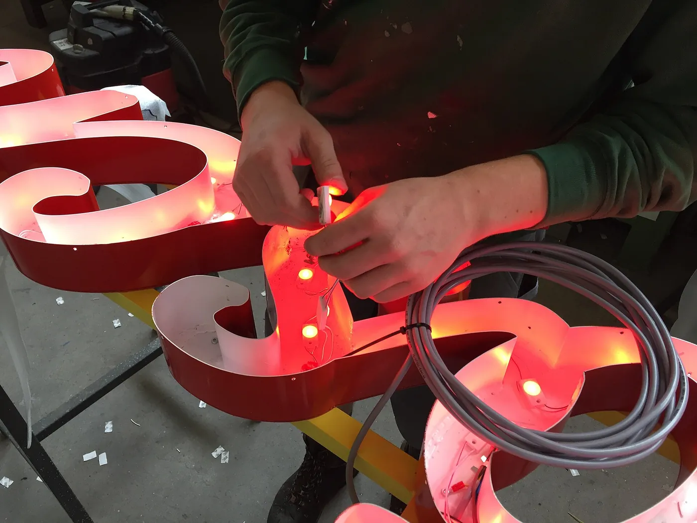 LED modules being fitted and checked inside a dimensional letter.