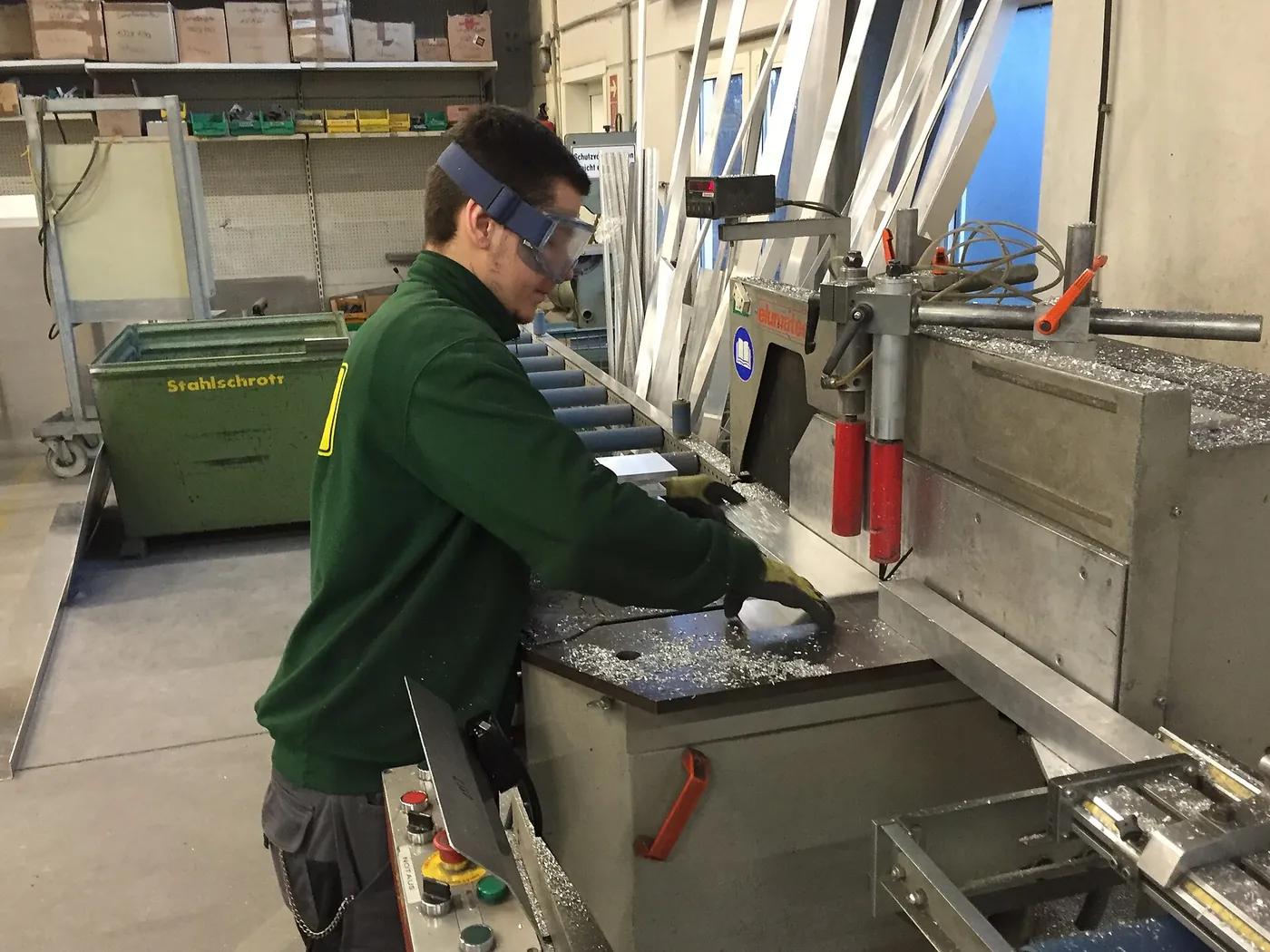 A fabricator cutting aluminium sections for signage.