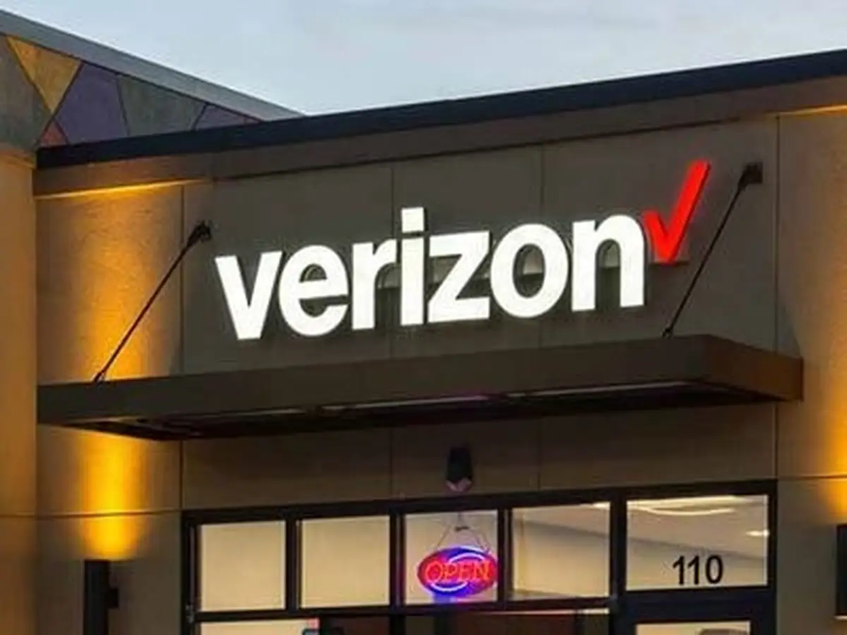 Illuminated letters mounted across a commercial building fascia.